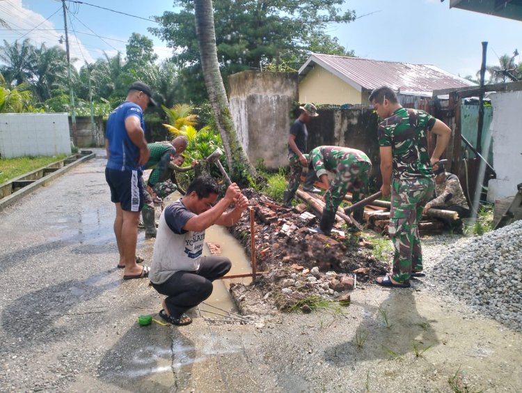 Personel Satgas TMMD ke 120 dan Warga Gali Parit Pembuatan Drainase Jalan Hiu Gang Saiyo