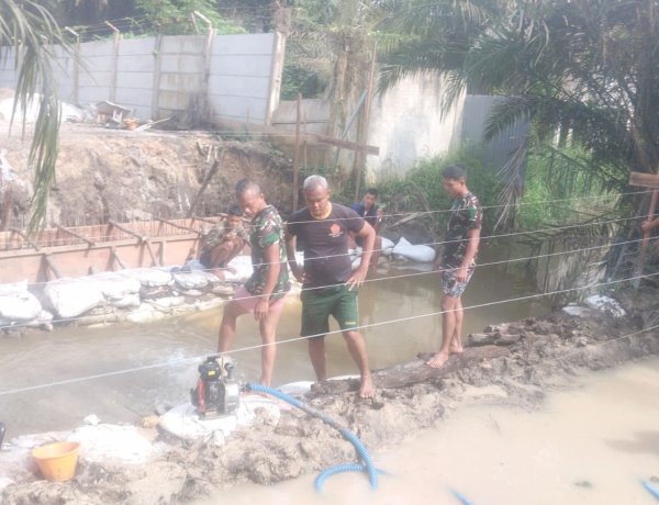 Personel Kodim 0301/Pekanbaru Bersama Warga Atasi Genangan di Area Pengecoran Jembatan